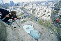 Cameraman Owen Newman filming from top of Nelson's Column in Traflagar Square, London for tv series "Living Isles", 1986