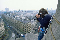 Owen Newman filming from the top of Nelson's column, London,  for tv series Living Isles, 1986