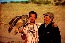 Nigel Marven, Nikolai Drozdov and Bubo (Great eagle owl) on location for filming of TV series 'Realms of the Russian Bear'