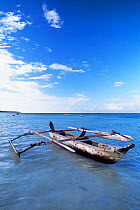 Traditional outrigger fishing canoe off Zanzibar Island, Tanzania, East Africa.