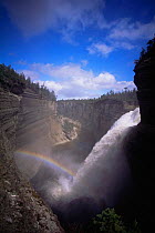 Rainbow across Vauréal falls on Anticosti Island, Quebec, Canada