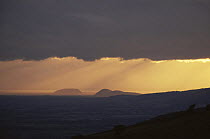 Sunset over Steep Holm, with the sun behind cloud, Bristol channel, UK