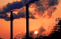 Air pollution: sun shining through smoke at the Sevalco plant, Avonmouth, Bristol, UK