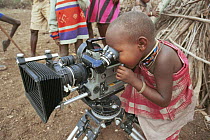 Masai child looking through the camera during filming OF BBC series Lifesense Masai Mara, Kenya, East Africa 1990