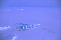 Aerial shor of tabular iceberg set in fast ice. Riiser-Larsen ice shelf. Antarctica