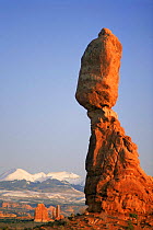 Balanced rock, snow covered La Sal mountains in background, Arches NP, Utah, USA