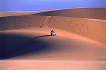 Landrover crossing sand dunes, Namib desert, Namibia
