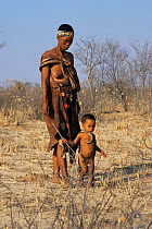 Kalahari Bushman tracking, mother teaches skills to child. Namibia
