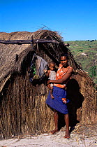 Woman with child outside makeshift home of sapphire seekers, near Ankarana SR, Madagascar