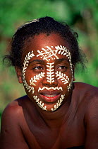 Local woman with sandalwood paste face decoration, Nosy Komba Island, Madagascar