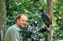 Camerman Mike Richards attempting to film Blyth's Hawk eagle (Spizaetus alboniger) Jurong Bird Park, Singapore, for BBC film special Eagle, 1996
