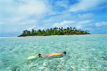 Woman snorkeling in front of tropical island,  Australia. Cocos Keeling Is.