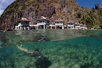Snorkler and cottages of El Nido resort, Philippines