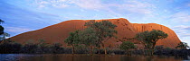 Ayers Rock surrounded by water in wet season, Uluru NP, Northern Territory, Australia.