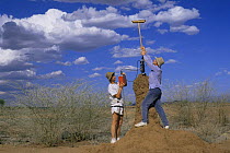 Alan Hayward filming in termite chimney with improvised broom cam mount, Kenya, 1990s