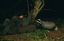 Photographer with curious Badger at night (Meles meles) Devon, UK