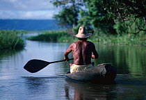 Varzea - flood plain of Amazon River with fisherman in canoe. Brazil, South America