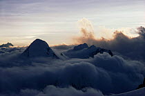 Sun setting over Pumori from North Col of Everest with clouds below, Himalayas, Nepal