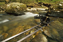 Film camera mounted on track to capture running water, 1998