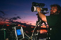 Camerman Owen Newman filming leopards at night, South Luangwa NP, Zambia, 19966