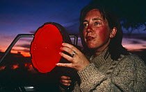 Amanda Barrett, producer,  holding infra-red light for night filming of Leopards, South Luangwa NP Zambia, 1996