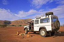 Simon King in Landrover on location filming dingos, Australia.