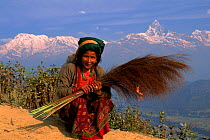 Nepalese woman, Anapurna mountain range in background, Pokhara, Nepal.