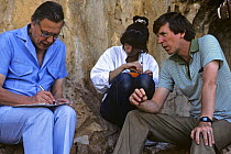 David Attenborough writing script with researcher Karen Bass and producer Andrew Neal, on location for BBC televsion programme "The First Eden", Spain, 1986