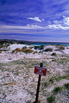 Surf bay with mine warning sign. East Falkland Island, Falkland Islands. War