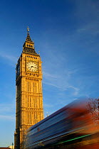 Big Ben clock tower at Parliament Square, London, and bus on the move, England.