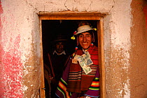 Quechua bridgegroom with money gifts pinned to his clothes as part of the ceremony, Bolivia