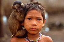 Arara Indian child with capuchin monkey perched on his shoulder. Amazon Basin. Brazil