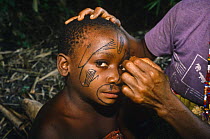 Bambuti pygmy portrait with face painting using charcoal and plant juice, Democratic Republic of Congo