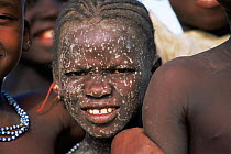 Portrait of young Falani girl with muddy face, Mali, West Africa