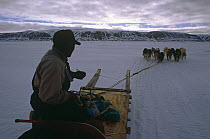 Inuit sledge being pulled by huskies, Lancaster Sound, Canadian Arctic