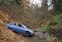 Vandalised car dumped in countryside beauty spot. South Yorkshire, England.