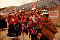 Quechua wedding ceremony. Bride and groom with money gifts pinned to their clothes, Bolivia