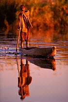 Local man in dugout canoe (mokoro), Okavango Delta, Botswana,