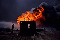 Burning oil well with water control from heat-shielding shed (post Gulf war). Kuwait, Arabia