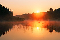 Sunrise over water at Turtle Flambeau Flowage (result of 1926 construction of dam to create reservoir) Wisconsin, USA