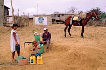 Filling water containers, rural water supply project. Pro Pueblo Foundation, Ecuador
