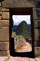 Huayana Picchu seen through stone arch. Machu Picchu, Peru.