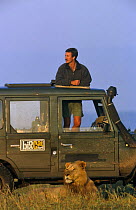 Presenter Jonathan Scott with African lion (Panthera leo) from Marsh Pride, Masai Mara NR, Kenya 1999 BBC Big Cat Diary series