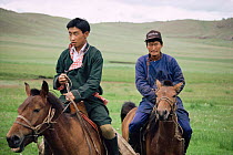 Mongolian riders on steppe, Hangay mountains, Mongolia.