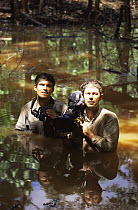Cameraman Mike Pitts (r) and producer Mark Linfield (l) in water filming Orang Utan programme 1998