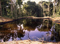 Pools of oily water beside oil well platforms. Amazonia, Ecuador