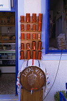 Wine measuring cups of various sizes outside shop for locally produced wine, Alonissos Island (Aegean) Greece