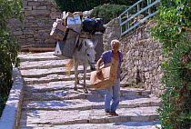 Garbage collector, with mule to carry rubbish, Alonissos Island, (Aegean) Greece