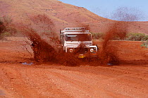 Land Rover Defender travelling through mud in Australia,
