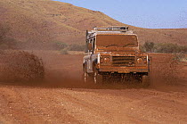 Land Rover Defender travelling along muddy track in Australian outback